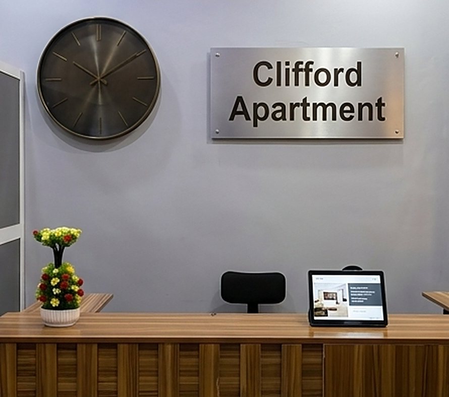 Reception desk with the Clifford Apartment sign